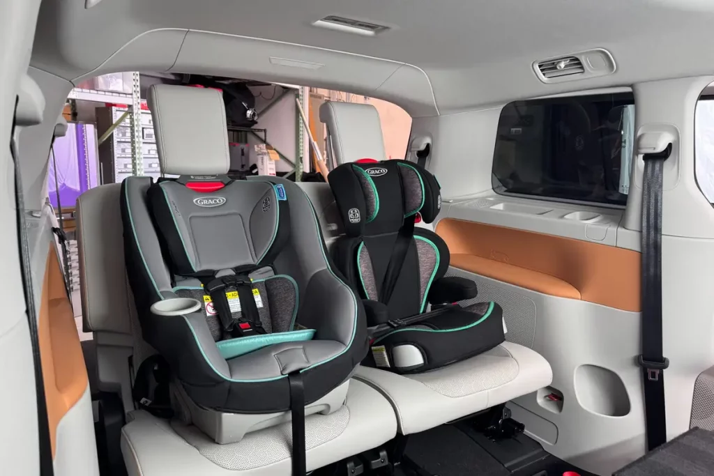 Child car seat inside a transport van, ensuring safety and comfort for young travelers during private transfers.